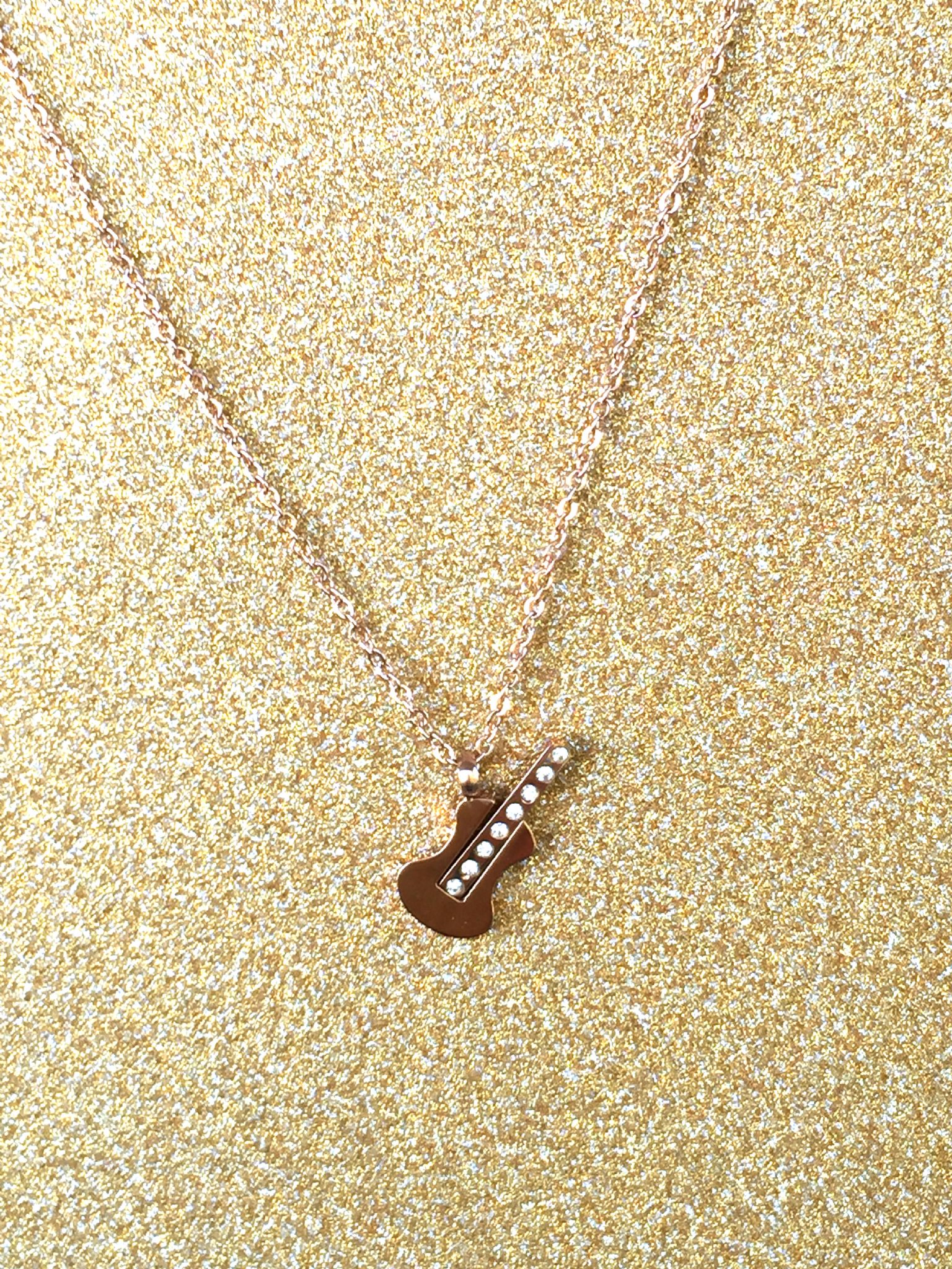 A beautiful butterfly pendant made of mother of pearl and emblazoned with small glittering crystals on a gold metal base. J020010